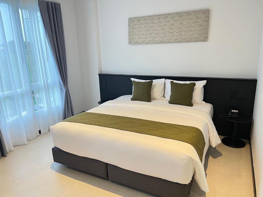Postel nebo postele na pokoji v ubytování Hotel Whitt Hua Hin