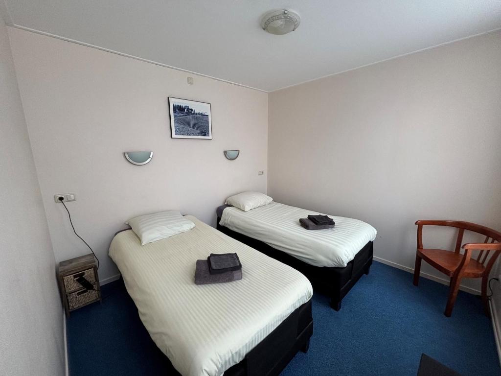 Postel nebo postele na pokoji v ubytování Hotel de Harmonie