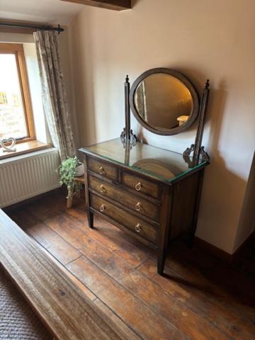 a mirror on top of a dresser in a room at The Shippon Barn - A delightful haven for families in Wirral