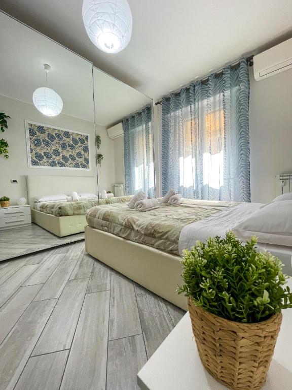 a bedroom with two beds and a mirror at Home In Town - Fiera Milano City near San Siro Stadium metropolitana M1 - M5 in Milan