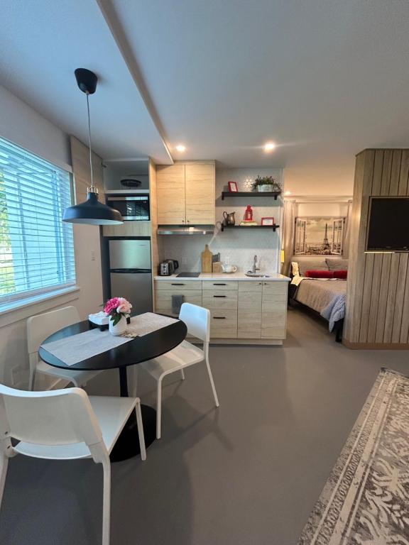 a kitchen and living room with a table and chairs at Window to Paris Studio on Lake Conroe in Montgomery