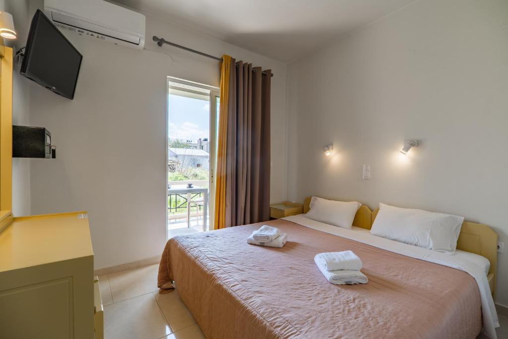 Postel nebo postele na pokoji v ubytování Rhoe Seaside Apartments