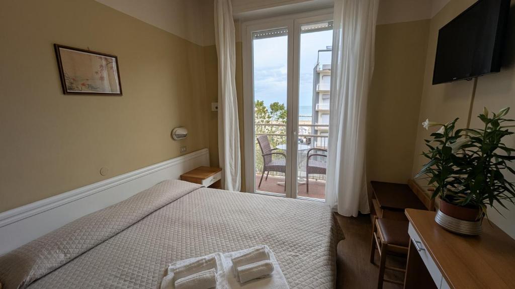 Postel nebo postele na pokoji v ubytování Hotel Boston
