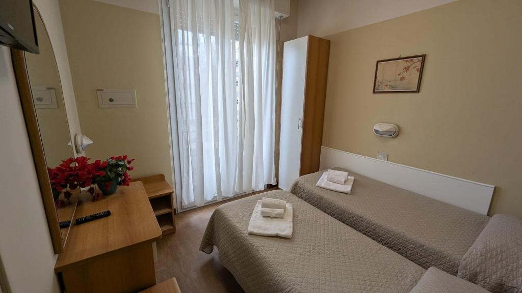 Postel nebo postele na pokoji v ubytování Hotel Boston