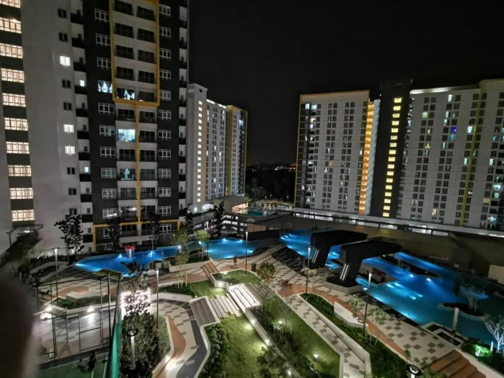 a view of a city at night with buildings at ForeverHomeStayNilai in Nilai