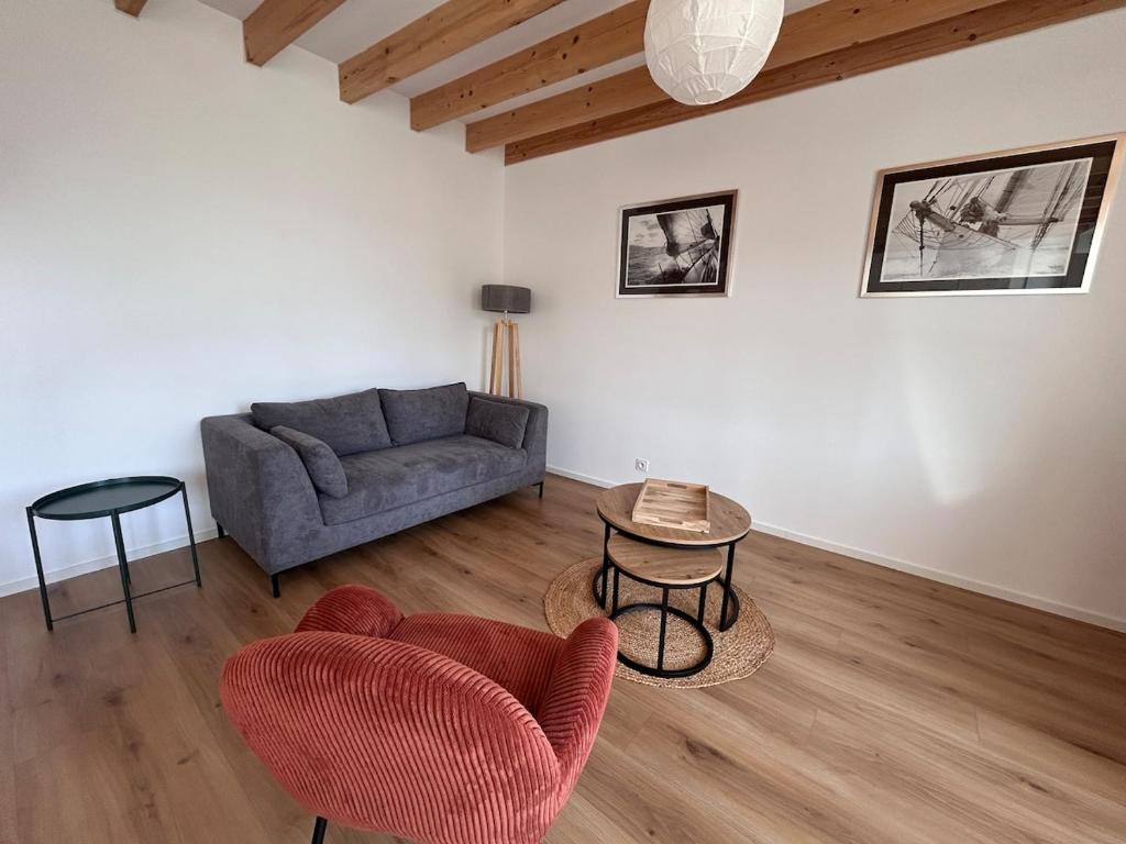 a living room with a couch and a table at La Pause Binicaise - Maison proche plage in Binic-Etables-sur-Mer