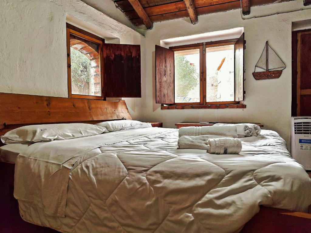 A bed or beds in a room at Case Rurali Pentedattilo