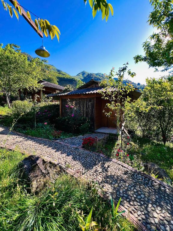 a house with a gravel driveway in front of a house at Tao Tay House - Ta Van in Sapa