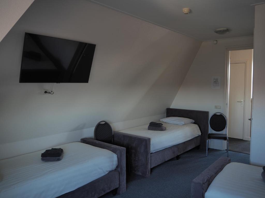 Postel nebo postele na pokoji v ubytování Hotel de Harmonie