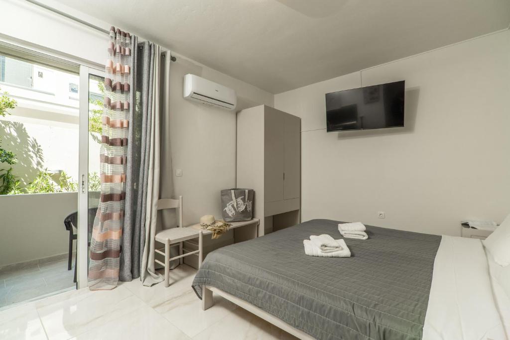 Postel nebo postele na pokoji v ubytování Rhoe Seaside Apartments