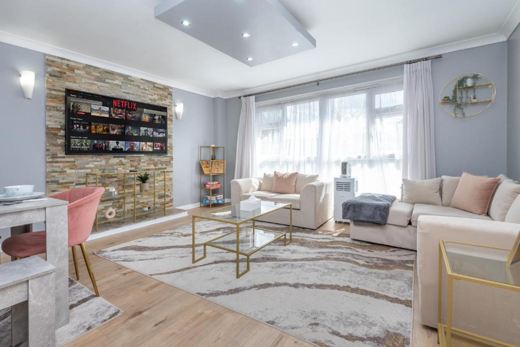 a living room with a couch and a table at Spacious 2BR home in Croydon with parking in Wallington