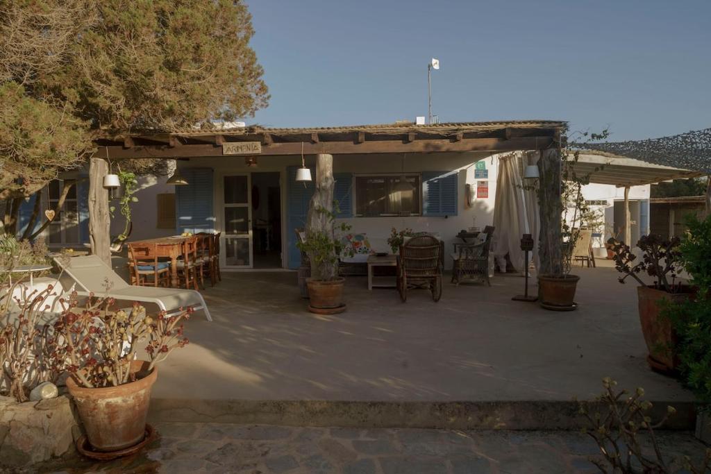 a patio with a table and chairs in front of a house at Casa Armonia in Illes Balears