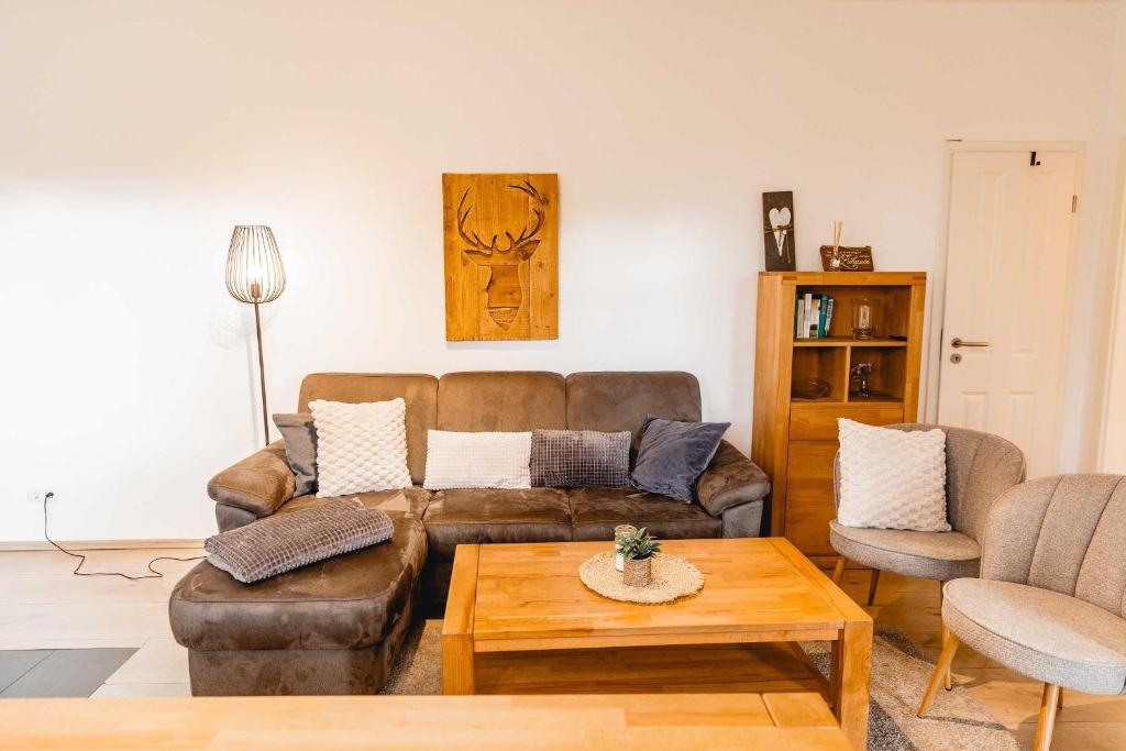a living room with a couch and a coffee table at Huxfeld-Hof - Landlust in Grasberg