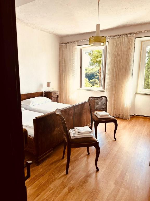 a bedroom with a bed and a couch and a chair at Albergo della Posta in Astano