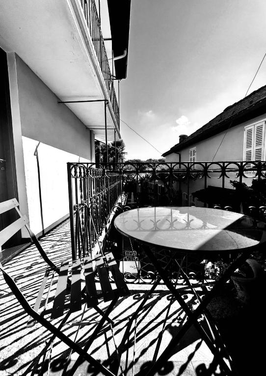 a table and chairs on a balcony with a surfboard at Albergo della Posta in Astano