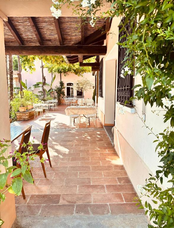 a patio with chairs and a table on a building at Albergo della Posta in Astano