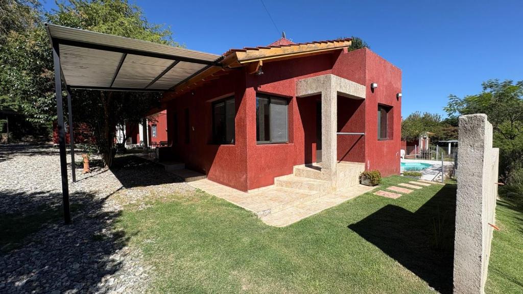 a small red house with a roof at Luz del Rincón in Merlo