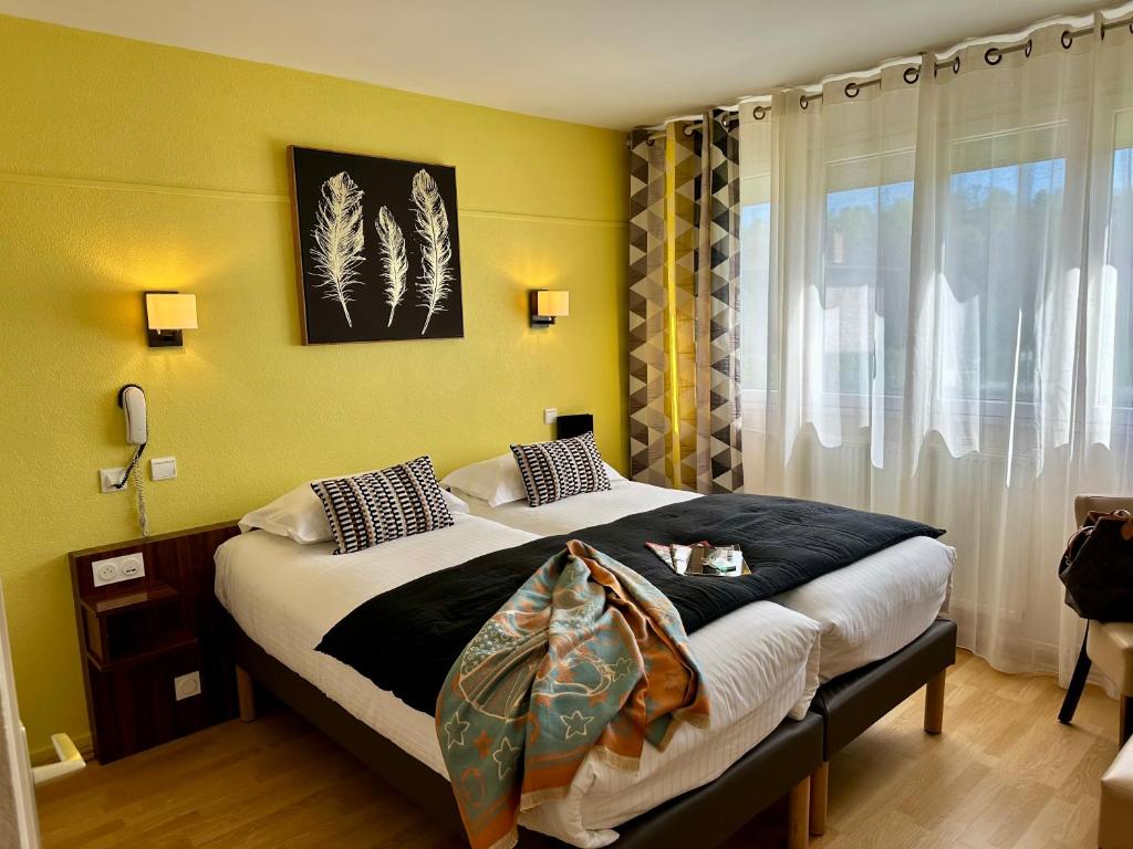 Postel nebo postele na pokoji v ubytování Hôtel Brun