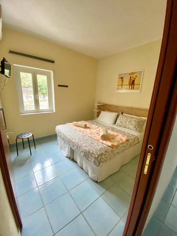 Postel nebo postele na pokoji v ubytování B&B Villa Rosa Angrisano