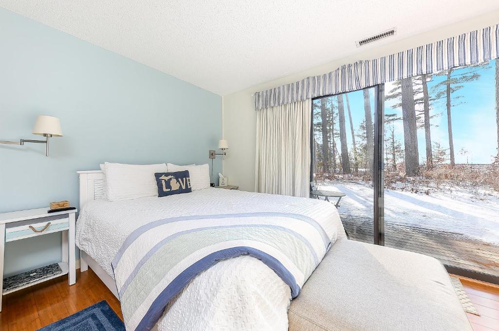 een slaapkamer met een bed en een groot raam bij Lovely Beachside Studio 5679 in Williamsburg