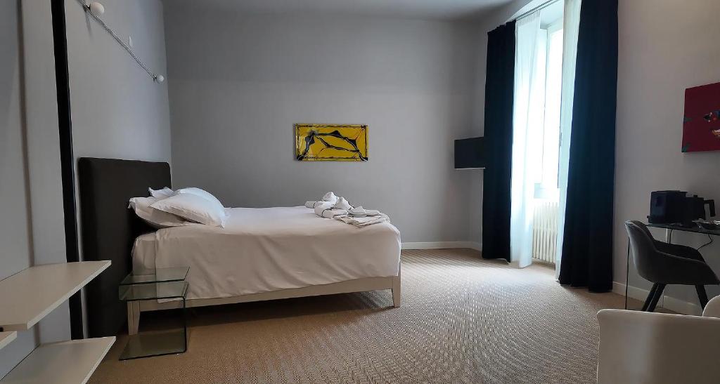 Postel nebo postele na pokoji v ubytování Amelié Lago d’Orta Hotel