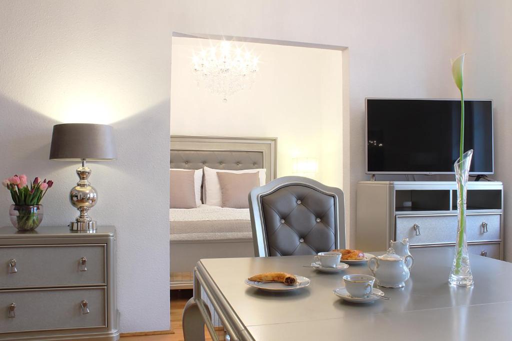 a living room filled with furniture and a tv at Milford Suites Budapest in Budapest
