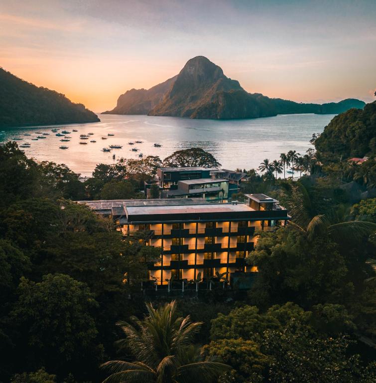a view of a resort on the water with a mountain at The Funny Lion - El Nido in El Nido