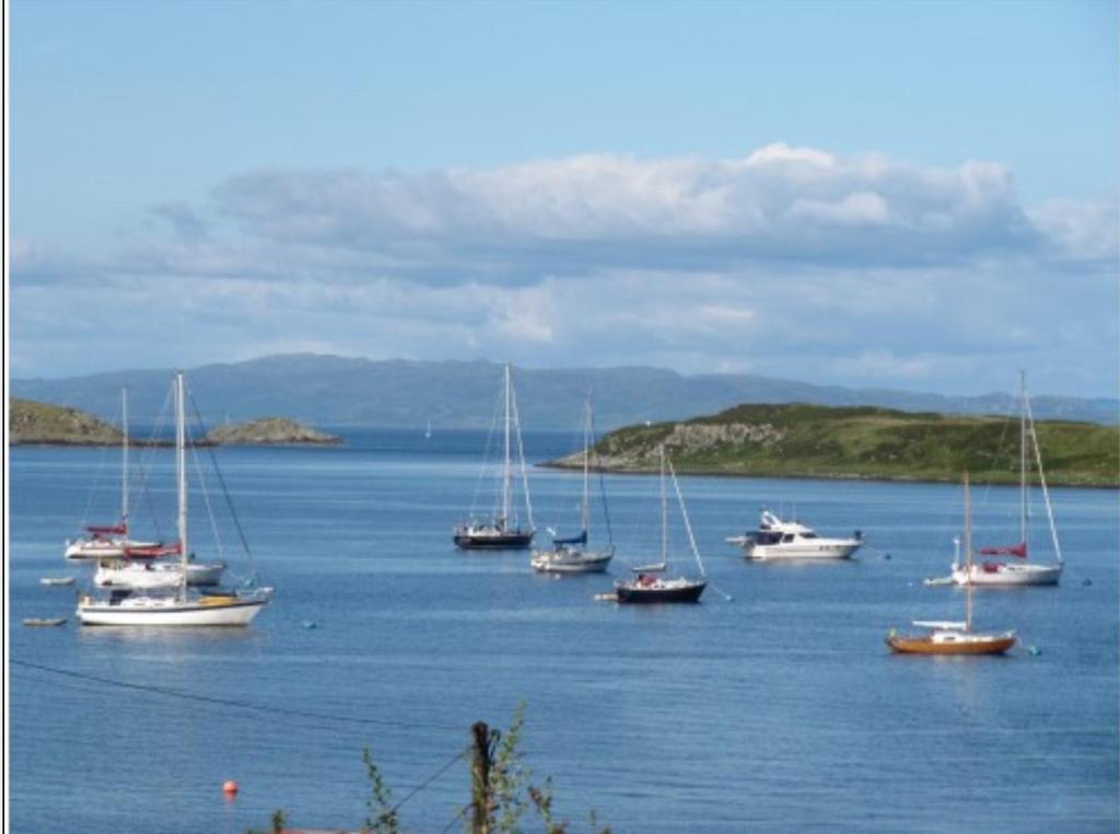 a group of boats in a large body of water at Braeside Craighouse Jura in Craighouse