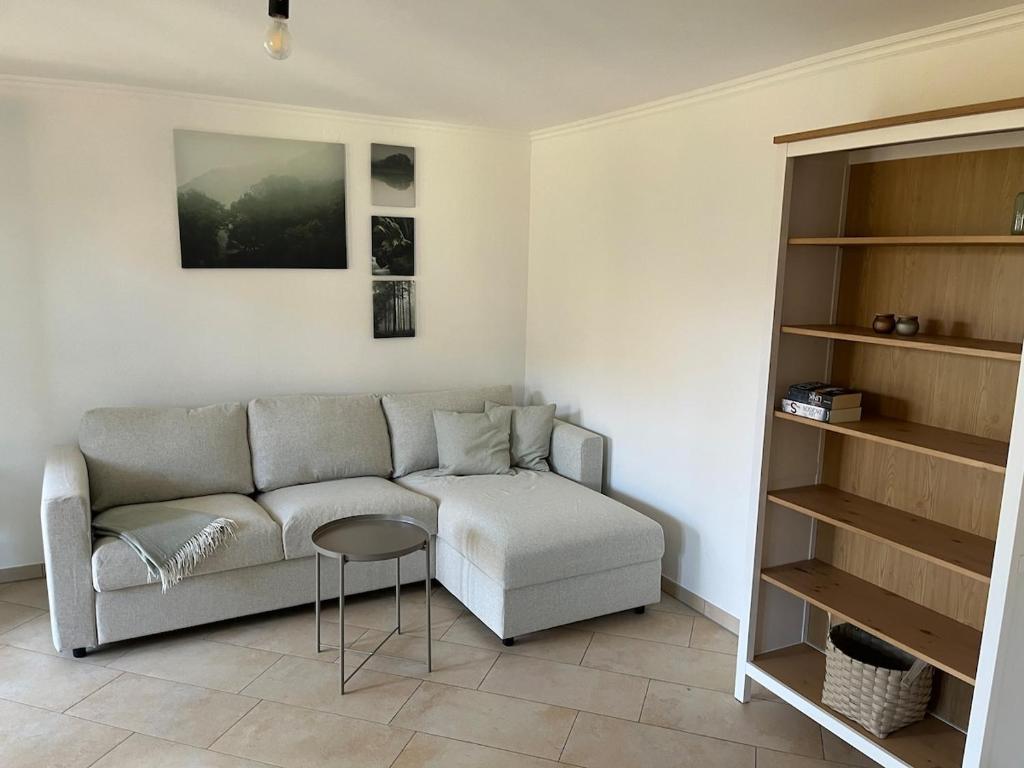 a living room with a couch and a stool at 2 Personen Appartement Sonnental in Greiling
