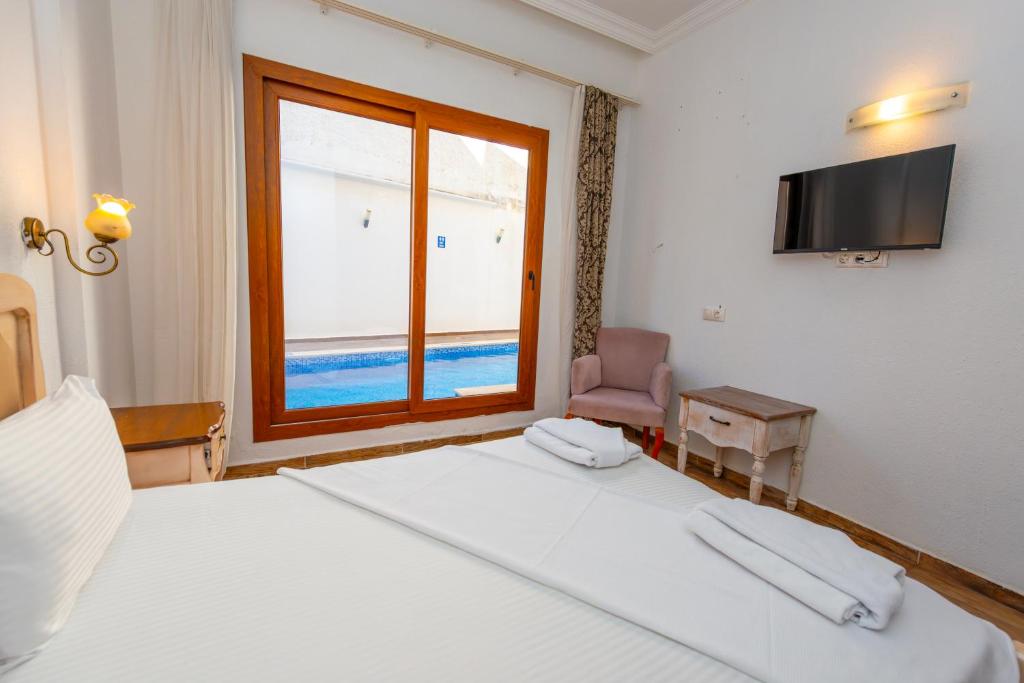 Postel nebo postele na pokoji v ubytování Cennet Life Hotel
