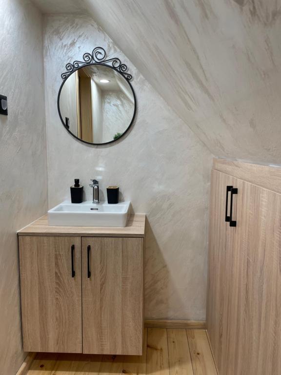 a bathroom with a sink and a mirror at Mokrogorski konaci in Mokra Gora