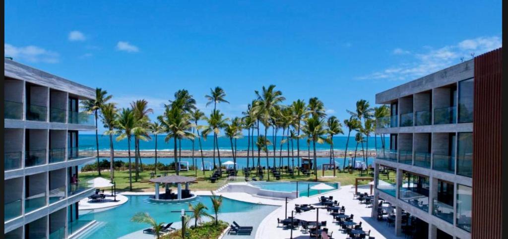 a view of a resort with a pool and palm trees at Porto Alto Resort in Porto De Galinhas