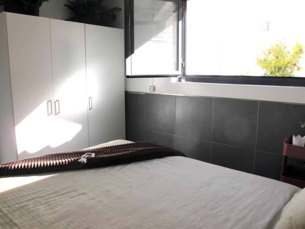 A bed or beds in a room at Apartamento ALDAMY