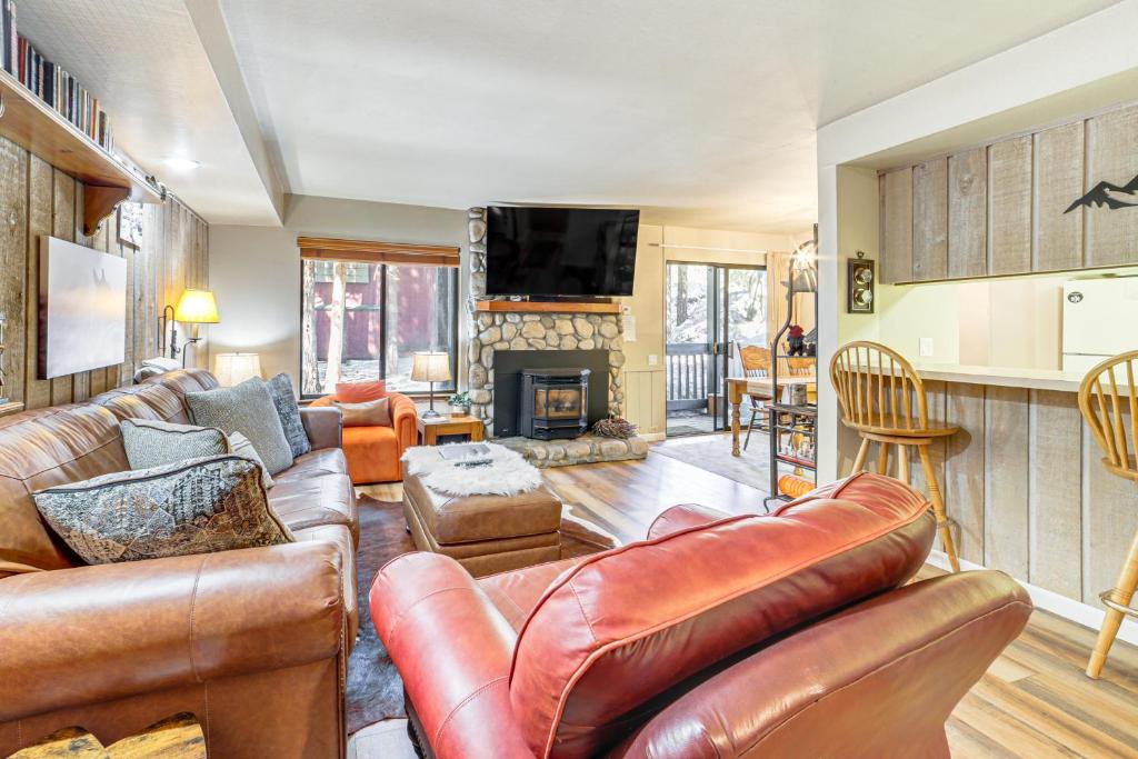 a living room with leather furniture and a fireplace at Walk to Shops & Eats: Mammoth Lakes Condo w/ Pool in Mammoth Lakes