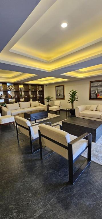 a lobby with couches and couches in a building at Torre 5 Mazatlán Versace Style in Mazatlán