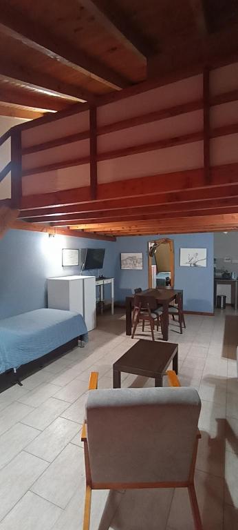 a living room with a couch and a table at Villa La Angostura in Villa La Angostura