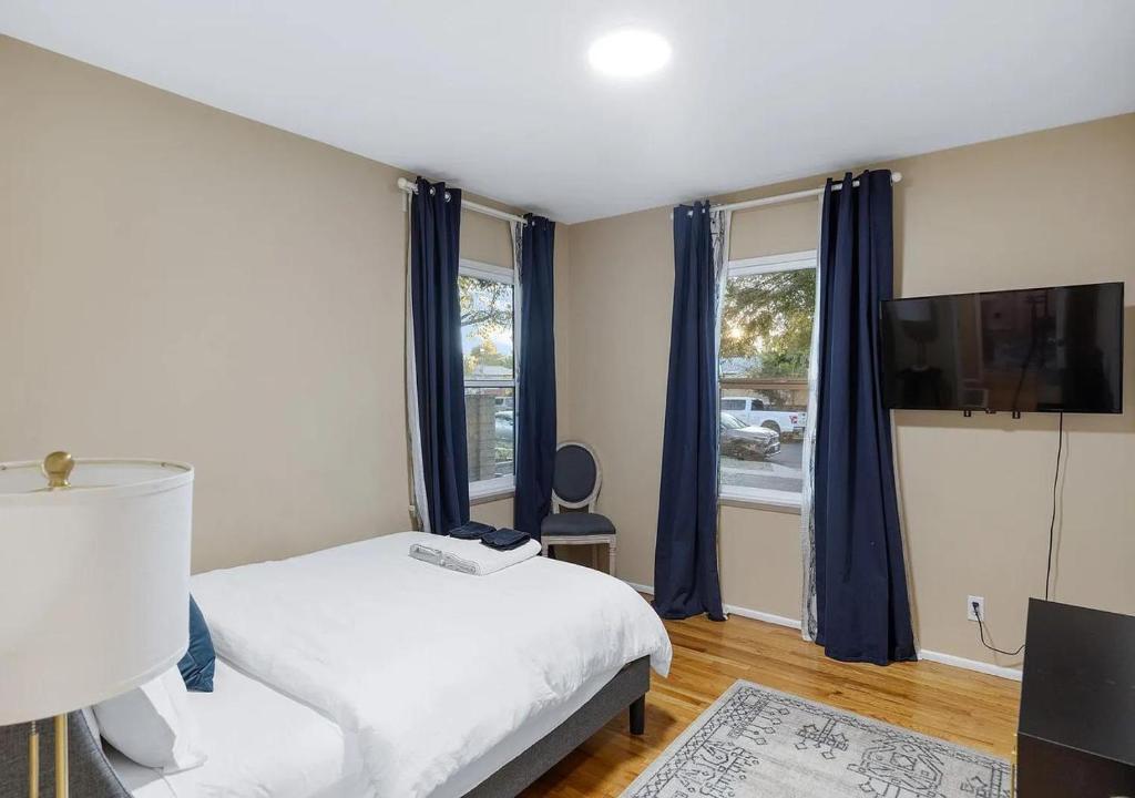 a bedroom with a bed and a large window at Balcom Breeze Escape in Los Angeles
