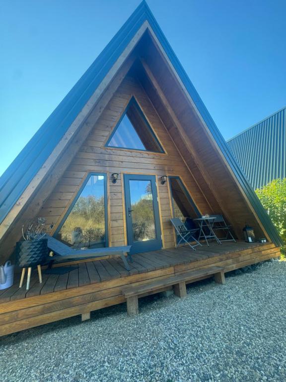 a cabin with a pitched roof with windows at Villa Kosta in Srb