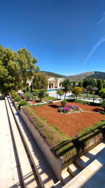 a park with a garden with flowers and trees at قصر تل الرمان in Ar Rummān