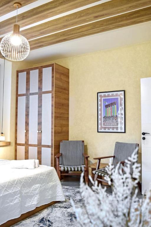 a bedroom with a bed and two chairs in it at Apartment in Jounieh - J707 in Al Bāţiyah