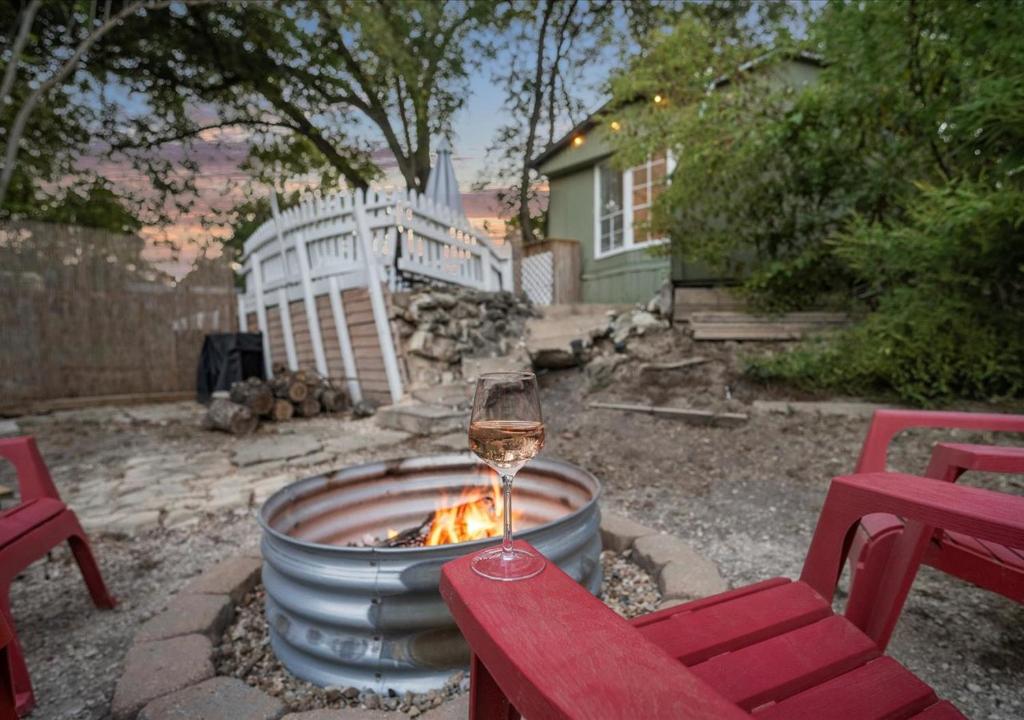 ein Glas Wein neben einer Feuerstelle in der Unterkunft Hot Tub, Fire pit & Pet-friendly Riverside Retreat in New Braunfels