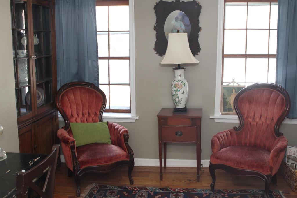 two chairs and a lamp in a living room at Armory Quarters B in Harpers Ferry