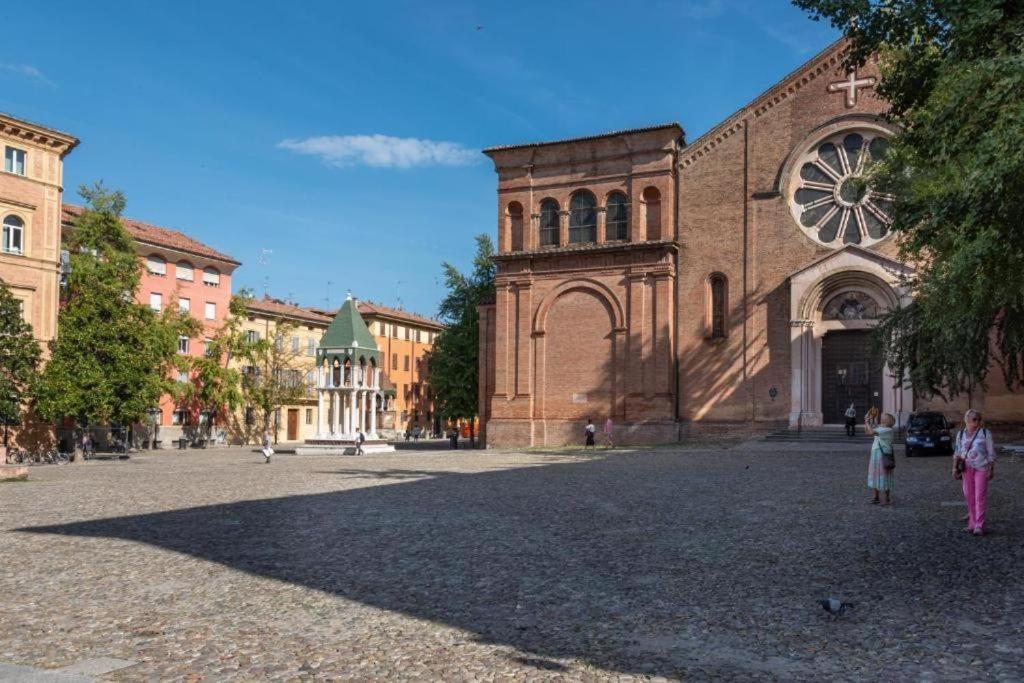 a woman and two children standing in front of a church at TRIBUNALE 4 LUXURY Rooms - BEDinBOLOGNACENTRO PALACE H in Bologna
