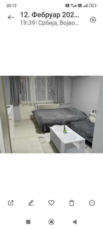 a room with a bed and a coffee table at Lenka 2 in Sremska Mitrovica