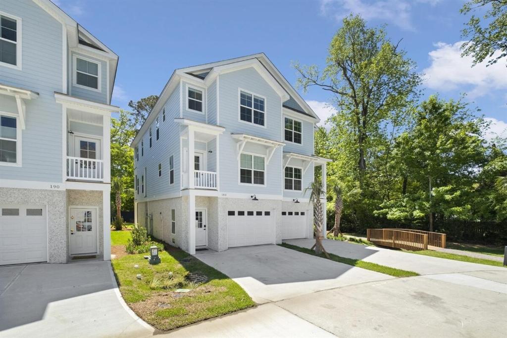 a large white house with a driveway at Brand New LUX Townhome-Mins to Beaches, Game Room! in Hilton Head Island
