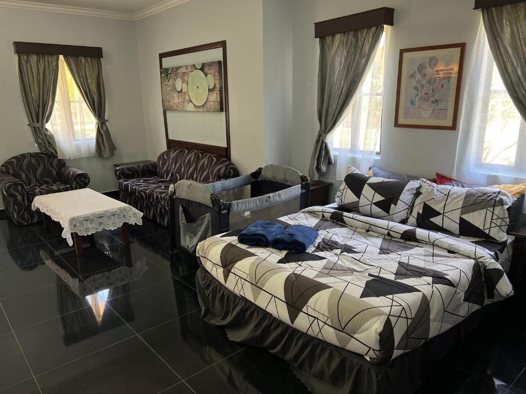 a living room with a bed and a couch at Swiss Court Holiday Apartments in Lumut