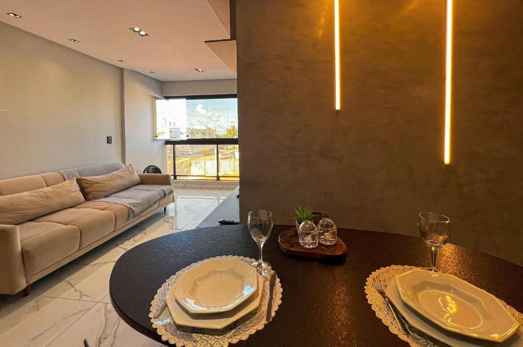 a living room with a table and a couch at Duplex Super Charmoso 200m Praia Bessa 3 Pessoas in Nossa Senhora do Livramento