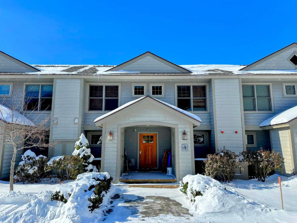 a house with a red door in the snow at SH5 Luxurious Stone Hill Townhome in Carroll