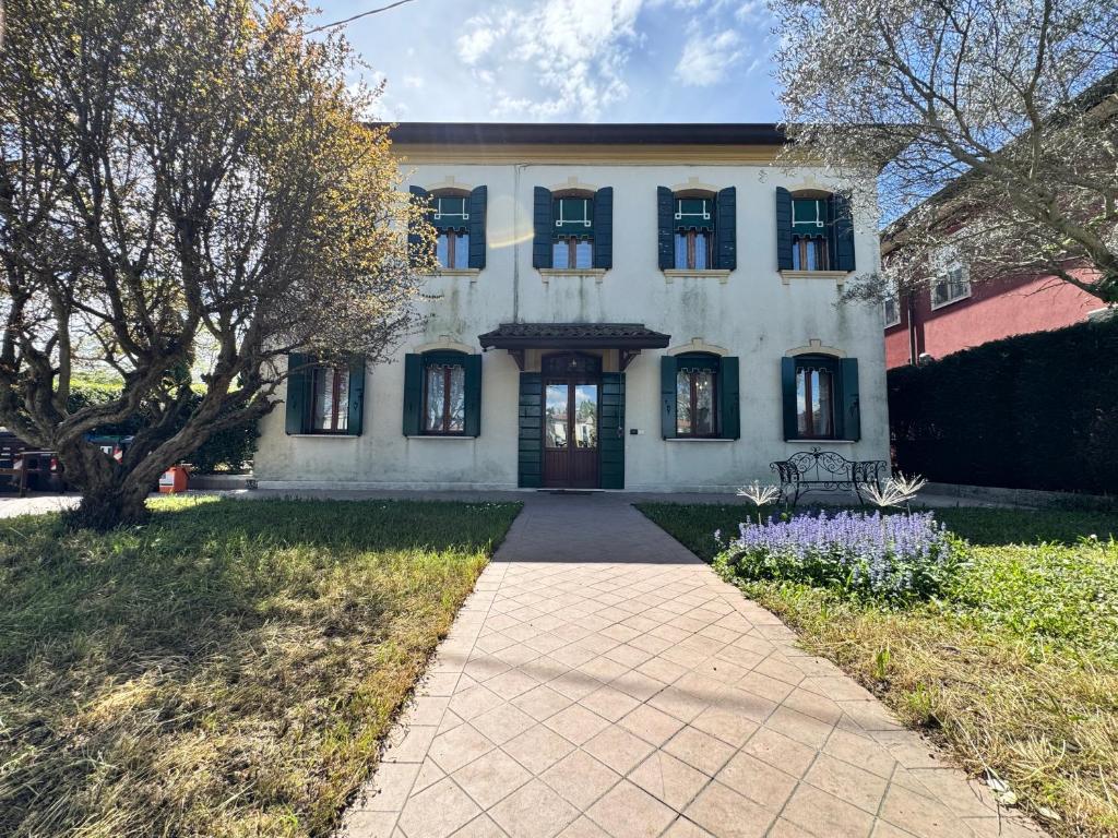 a large white house with a walkway in front of it at Villa Gardenia - Comfort & Privacy - River View in Mira