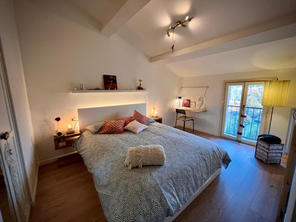 a bedroom with a bed with a blue comforter at Little Home Italy in Castelvetro di Modena